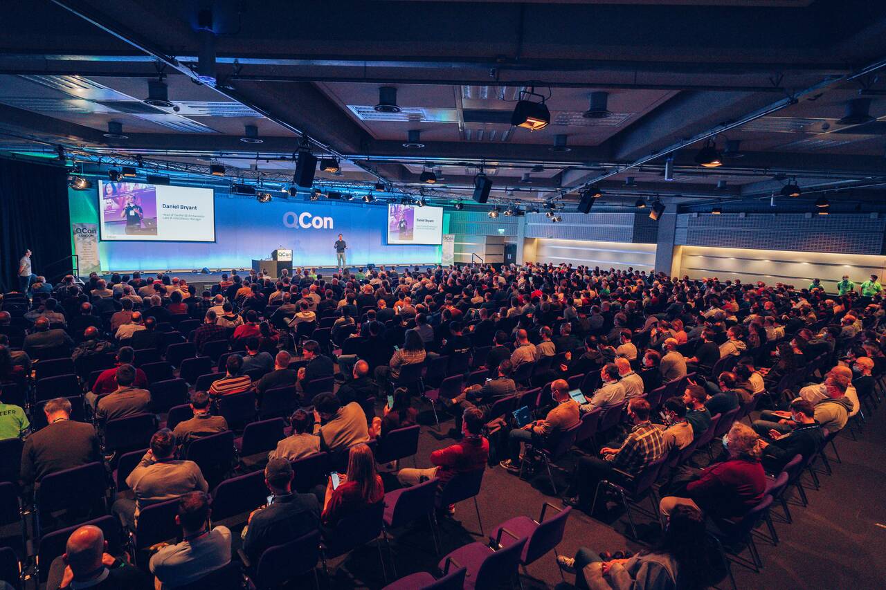 A packed keynote room at a QCon software conference